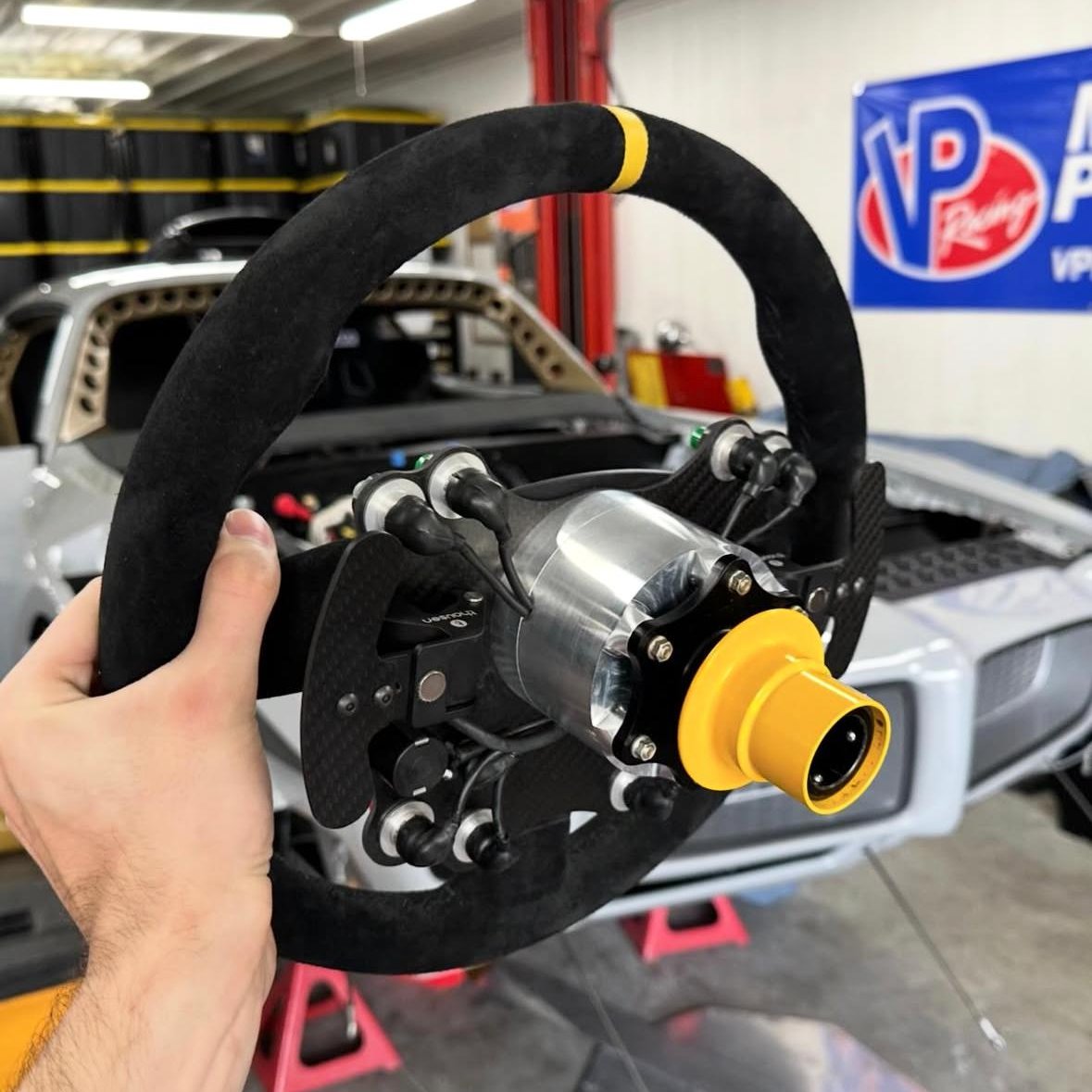 Precision-machined steering wheel hub with anodized quick-release coupler
